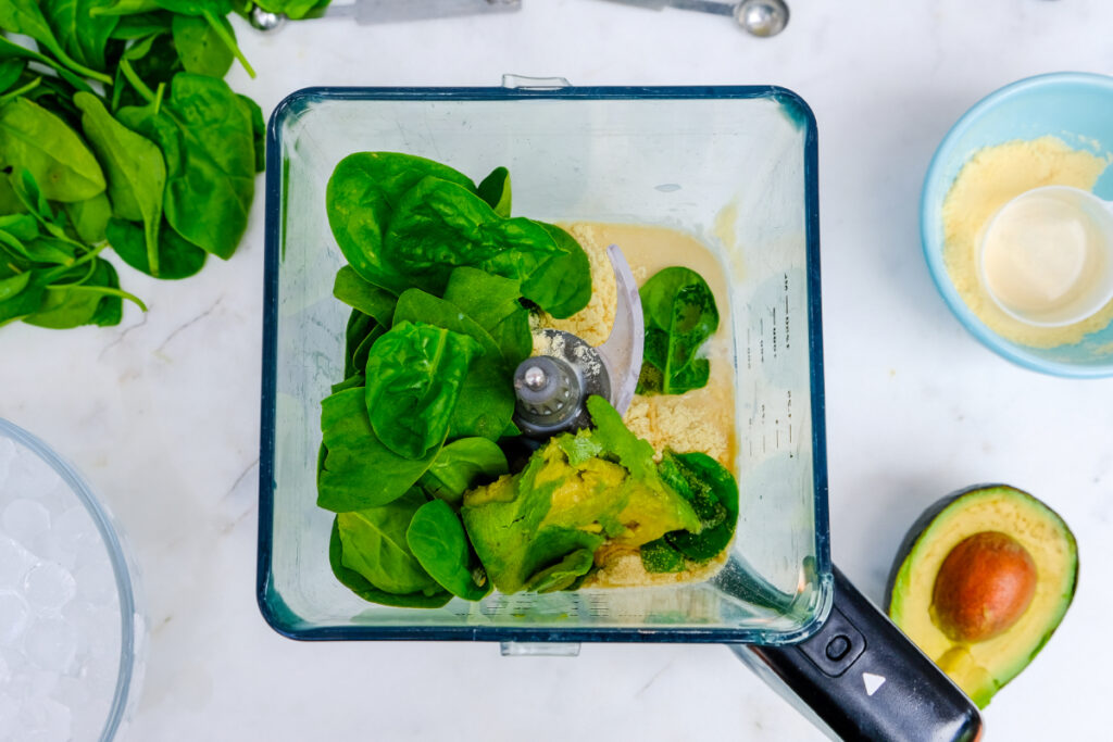 Ingredients for spinach smoothie in a blender.