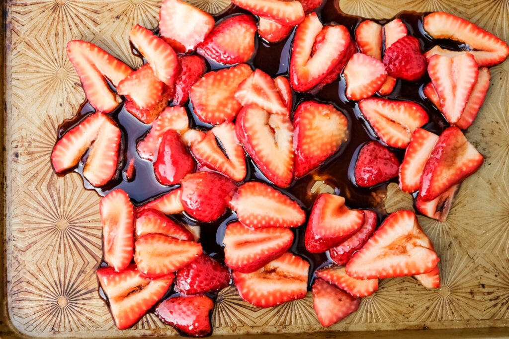 Strawberries on a baking sheet before roasting. 