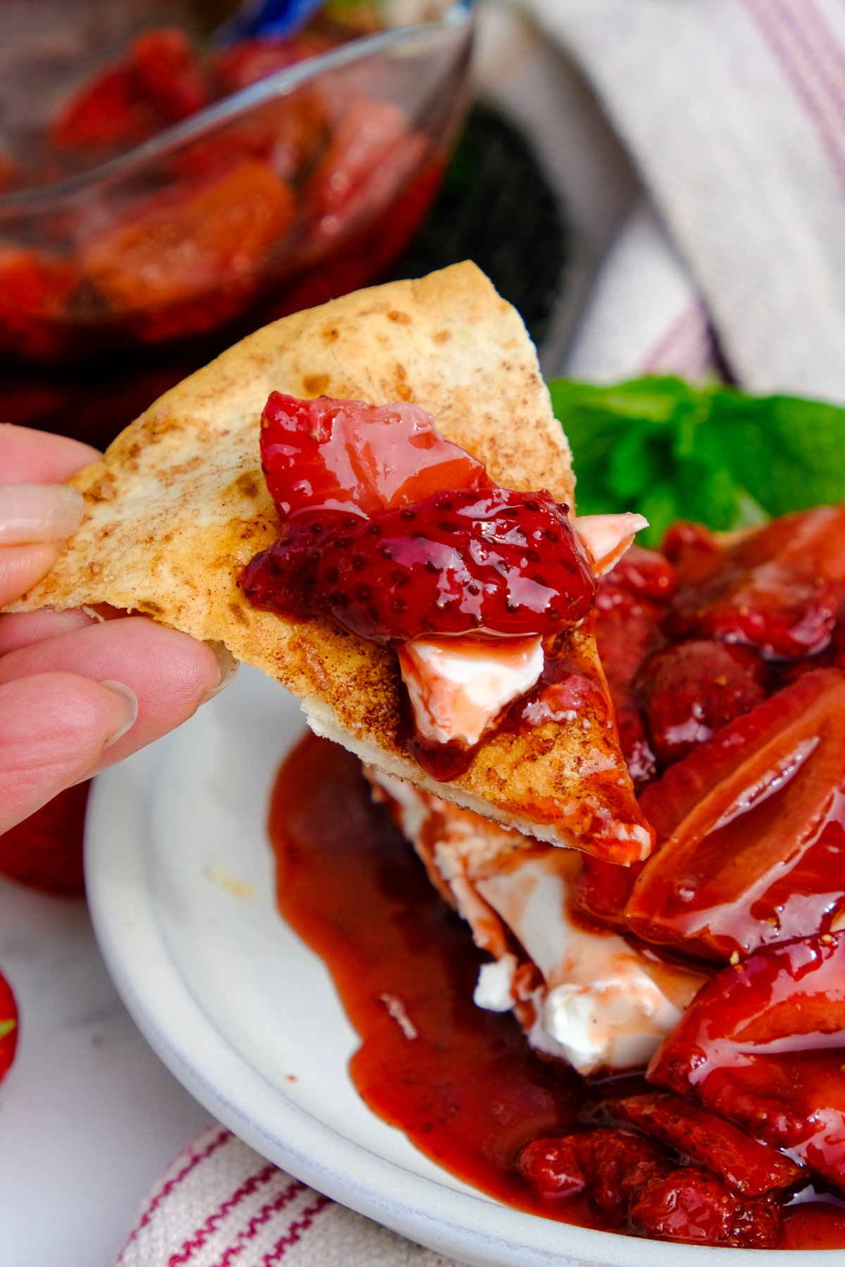 A cinnamon chip with roasted balsamic strawberries with cream cheese. 