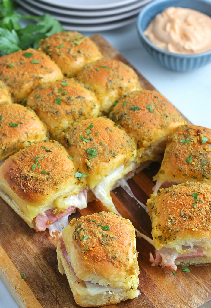 Ham And Cheese Sliders Topped With Butter Sauce The Foodie Affair