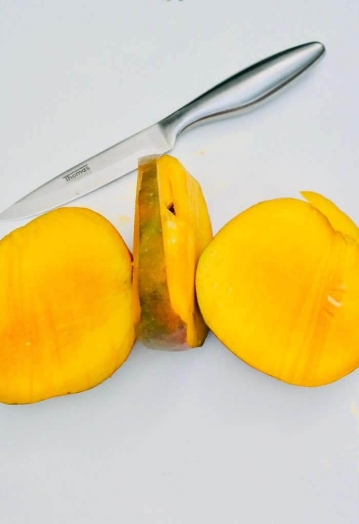 Fresh mango sliced avoiding the pit.