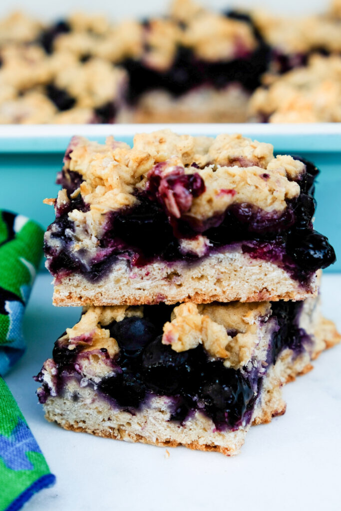 Two blueberry oatmeal bars stacked on each other. 