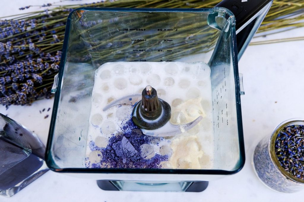 Ice and milk with lavender in a blender.