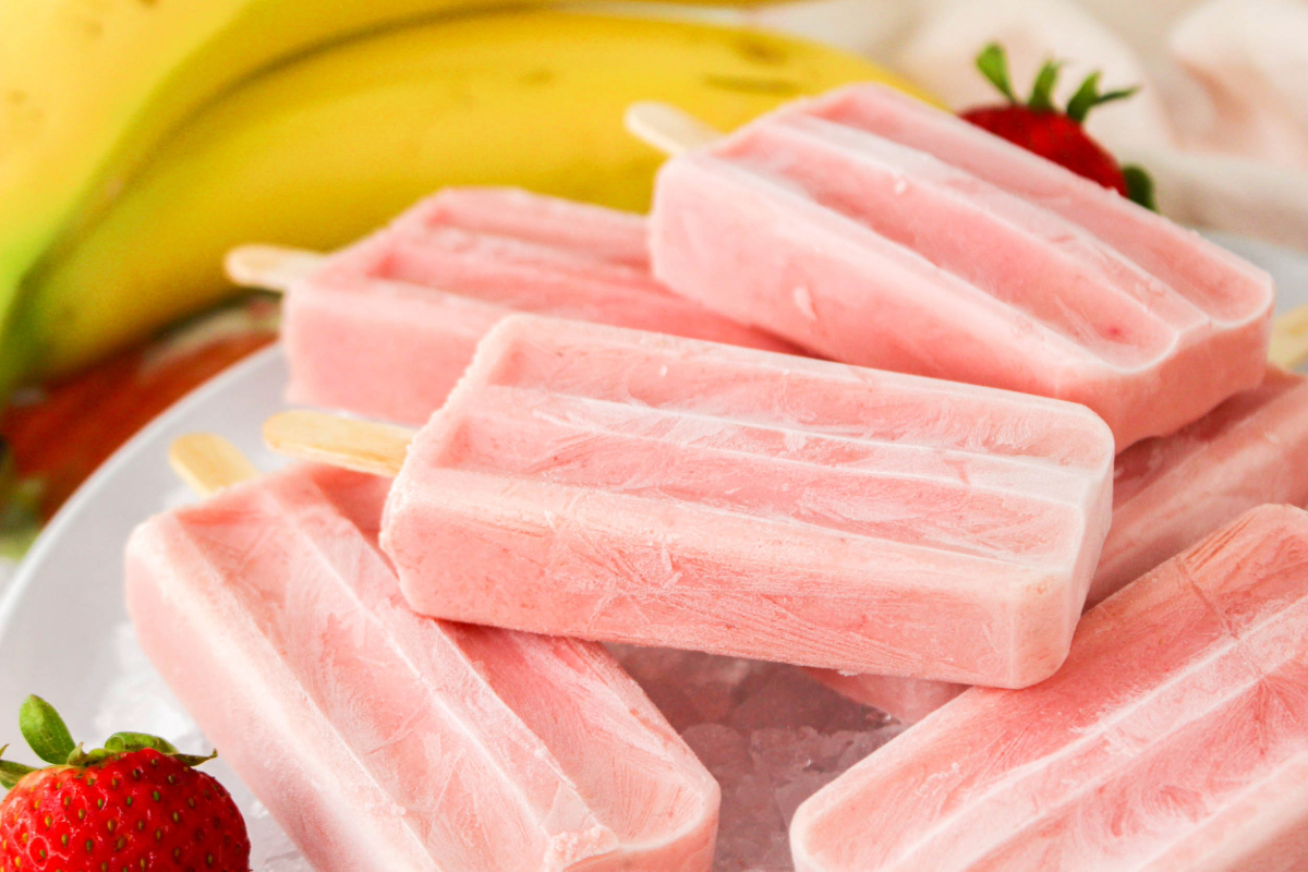 Popsicles made with fruit on a plate with ice. 